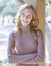 Laurel Snow smiling in a serene outdoor settings. 