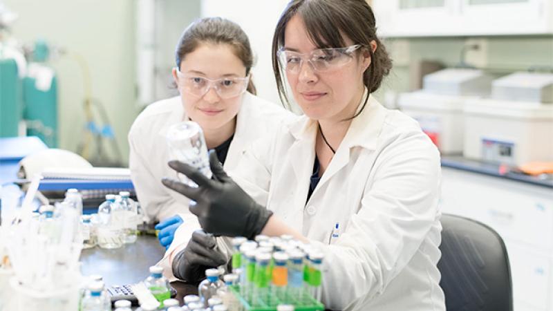 Two students work in a lab